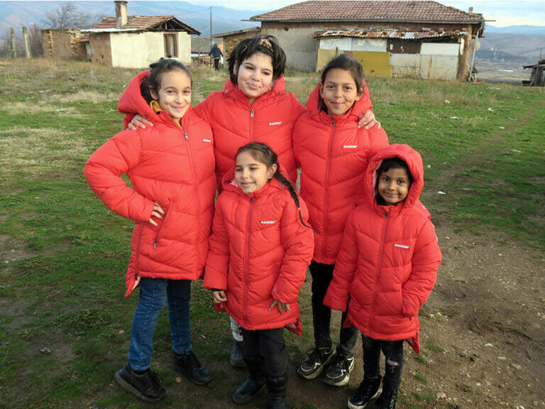 A group of girls in red jackets on a mission possible.