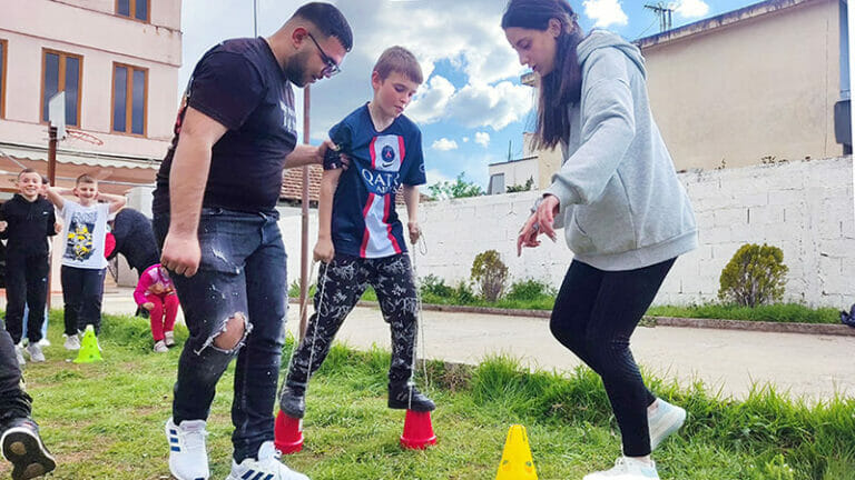 A group of people standing around a group of cones.